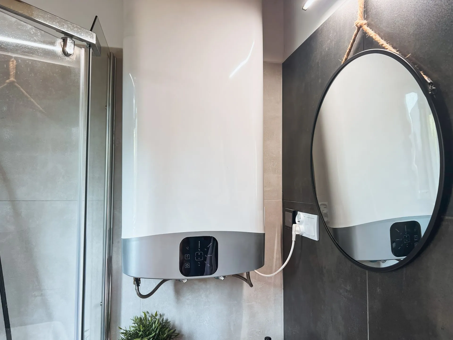A bathroom with a water heater and a round mirror